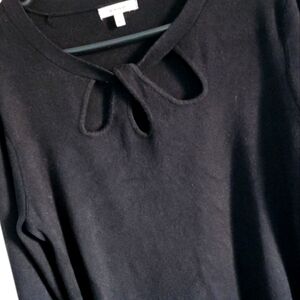 Black knit light weight long-sleeved sweater with three keyhole at neck.